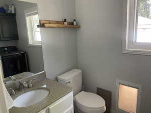 Half bathroom and laundry room off mud room/hallway