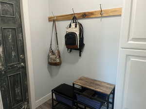 Mudroom featuring baseboards and wood finished floors