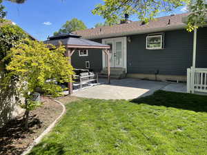 Back of house featuring a gazebo, outdoor lounge area, entry steps, a patio, and a yard