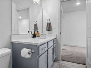 Upstairs hall bathroom with a large vanity with quartz counters and a full-sized bathtub and shower combination.