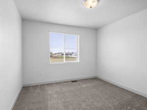 One of three upstairs bedrooms offering neutral decor and a large closet