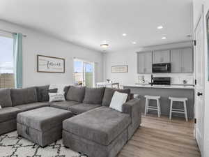 Recessed lighting, quartz countertops, breakfast bar and wood look flooring on the main floor.