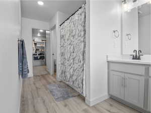 The primary suite offers wood look flooring, double vanity, walk-in closet and a separate room for the toilet.