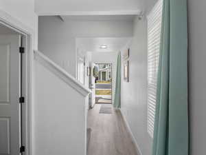 Large entry with wood-look hardwood floors and extra windows.