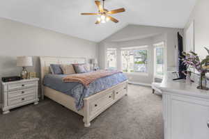 Your primary bedroom features a sunny bay window, soaring vaulted ceilings and a spa style bath