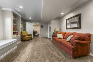 Basement family room with built in bookcases, window sear and fresh paint