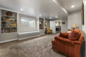 Basement family room with built in bookcases, window seat and fresh paint