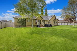 Lush backyard with mature trees, full fencing, landscape curbing an included shed and patio