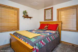 Carpeted bedroom with baseboards