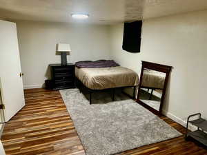Bedroom featuring baseboards and wood finished floors