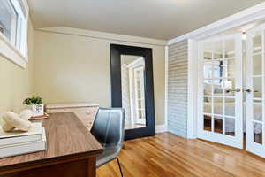 Office featuring french doors, lofted ceiling, and light wood-type flooring