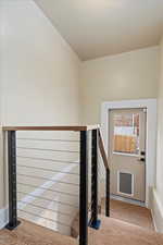 Stairs with baseboards and wood finished floors