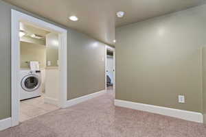 Laundry area featuring laundry area, washer / clothes dryer, carpet floors, tile patterned floors, and recessed lighting
