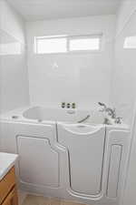 Walk-in jetted tub in primary bathroom
