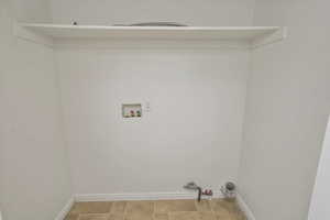 Laundry area featuring laundry area, hookup for a washing machine, baseboards, and hookup for a gas dryer
