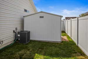 View of back of shed with a fenced backyard