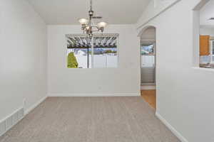 Dining area with arched walkway.