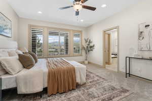 Bedroom with a ceiling fan, baseboards, ensuite bathroom, recessed lighting, and carpet flooring