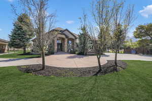 Obstructed view of property featuring a front lawn and stone siding