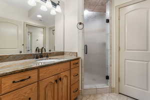 Full bath with visible vents, tile patterned floors, a stall shower, and vanity