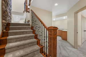 Stairway with recessed lighting, baseboards, and carpet floors