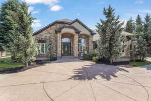 View of front of property with stucco siding and stone siding