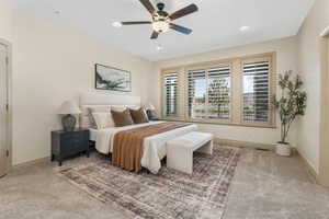 Carpeted bedroom featuring baseboards, recessed lighting, ceiling fan, and visible vents