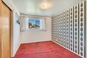 Bedroom with baseboards, and carpet