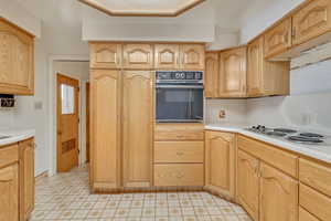 Kitchen featuring light countertops, electric stovetop, and oven