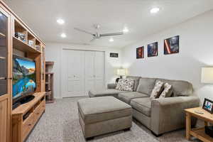 Living room featuring ceiling fan, recessed lighting, and carpet floors