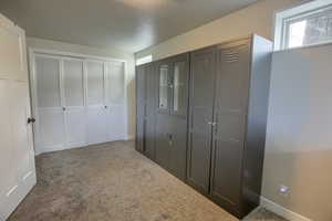 Bedroom/Office with baseboards and carpet