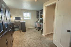 Bedroom/Office area with baseboards and light carpet