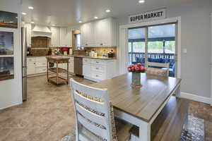 Dining space with baseboards, recessed lighting, and stone tile floors