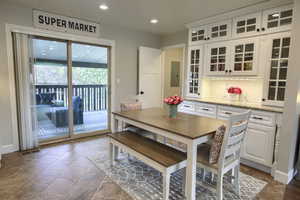 Dining room featuring stone tile floors, recessed lighting, featuring built in cabinetry