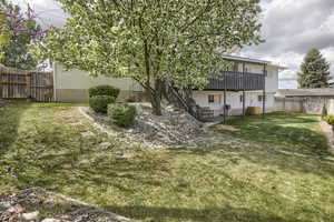 View of yard with a fenced backyard and a wooden deck