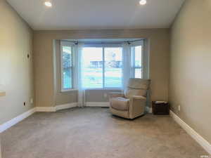 Primary bedroom sitting area overlooking large greenbelt area
