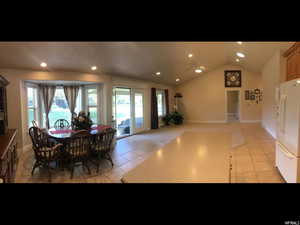 View from kitchen, dining area and family room, all with vaulted ceiling