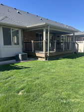 Rear view of home with beautiful covered deck to sit, relax and enjoy the view
