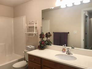 Bathroom with vanity, shower / bath combination, and toilet in fully finished basemement