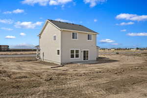 Rear view of property featuring stucco siding