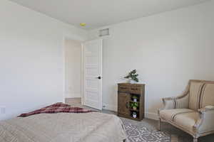 Bedroom featuring carpet floors and baseboards