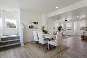 Dining space with stairs, recessed lighting, baseboards, a ceiling fan, and wood finished floors
