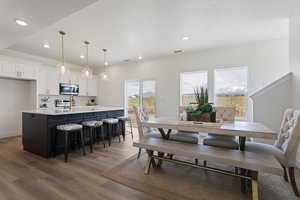 Dining space with recessed lighting, light wood finished floors, and visible vents