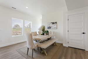 Dining room with recessed lighting, baseboards, and light wood finished floors