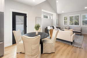 Dining space featuring recessed lighting, light wood-style flooring, and lofted ceiling