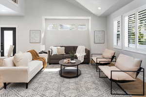 Living area featuring light wood-style floors, baseboards, recessed lighting, and lofted ceiling