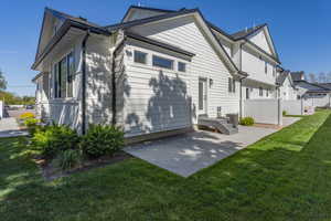 Back of house with a lawn, a patio area, fence, and cooling unit