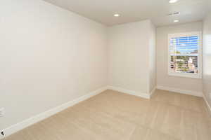 Unfurnished room featuring visible vents, recessed lighting, baseboards, and light colored carpet