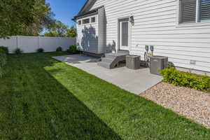 View of yard with fence, cooling unit, and a patio