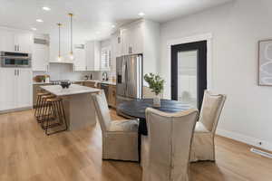 Dining space with baseboards, recessed lighting, light wood-style flooring, and visible vents